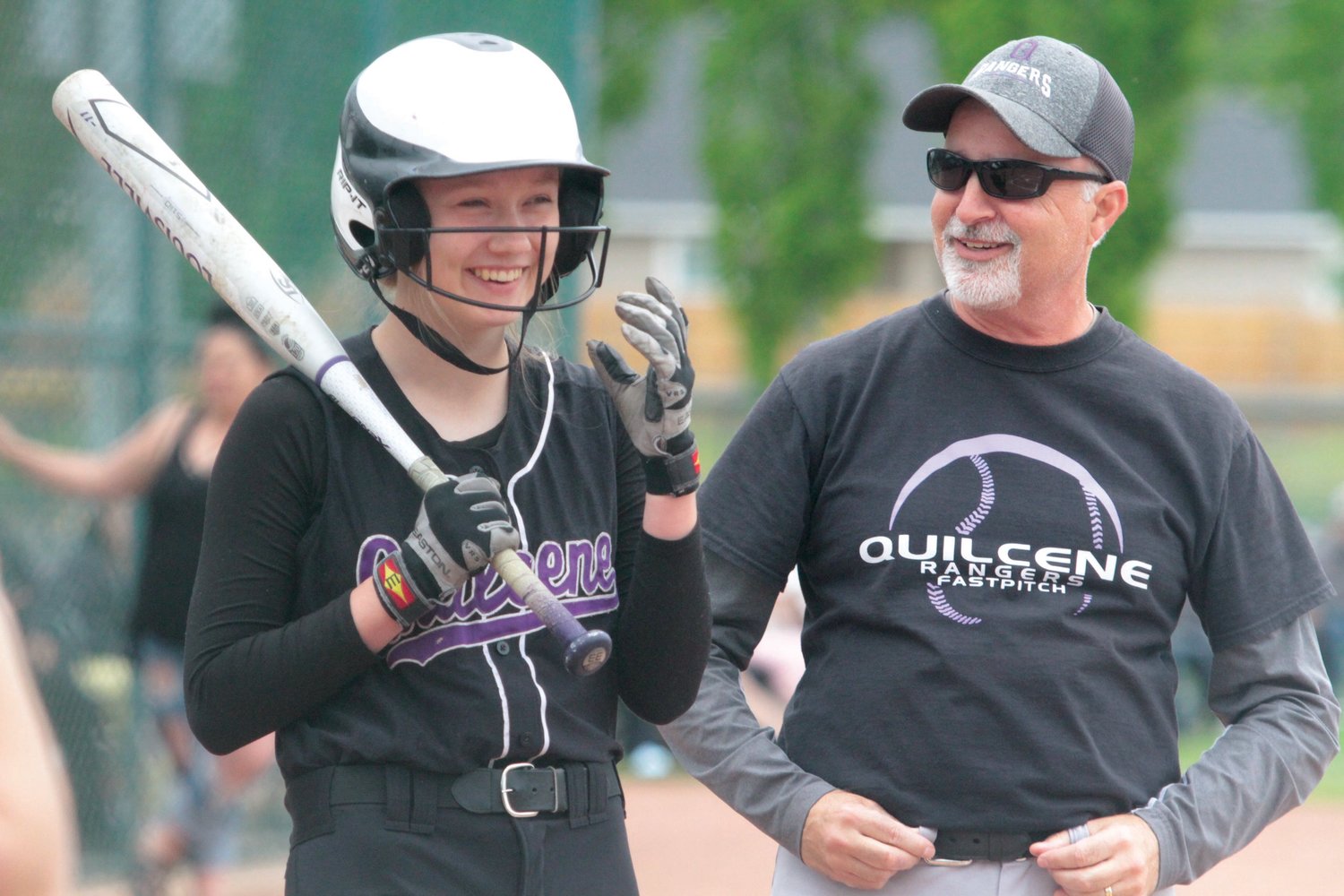Emery Reimann shares a laugh with Ranger Coach Mark Thompson before an at-bat against the Hornets.